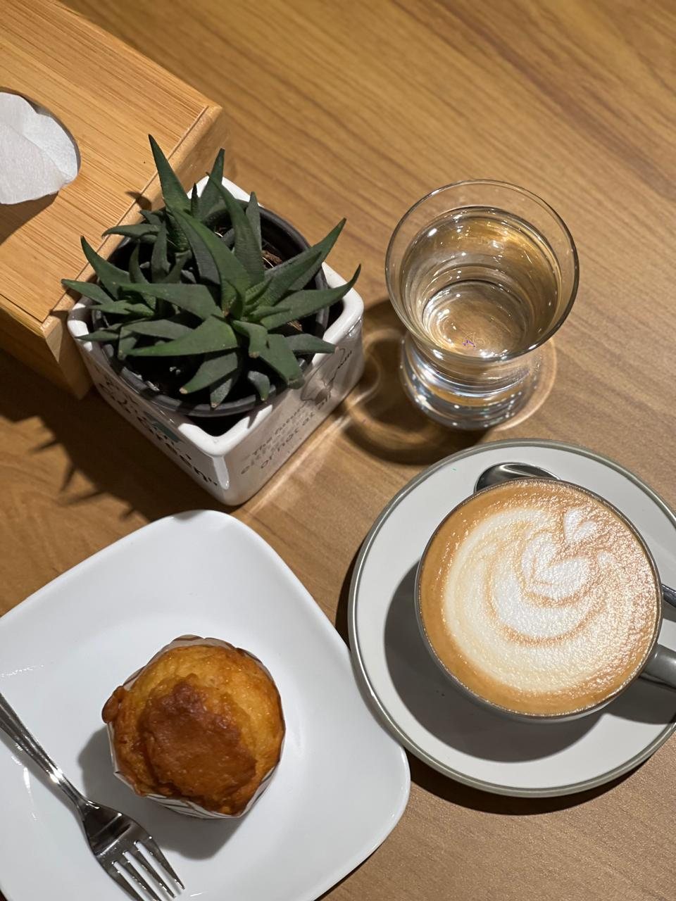 Latte and muffin on a wooden table